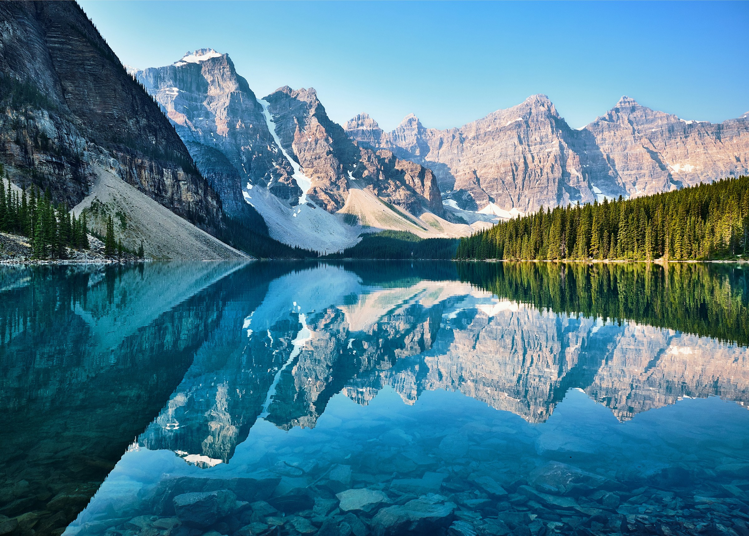 mountain lake with reflection of white peaks